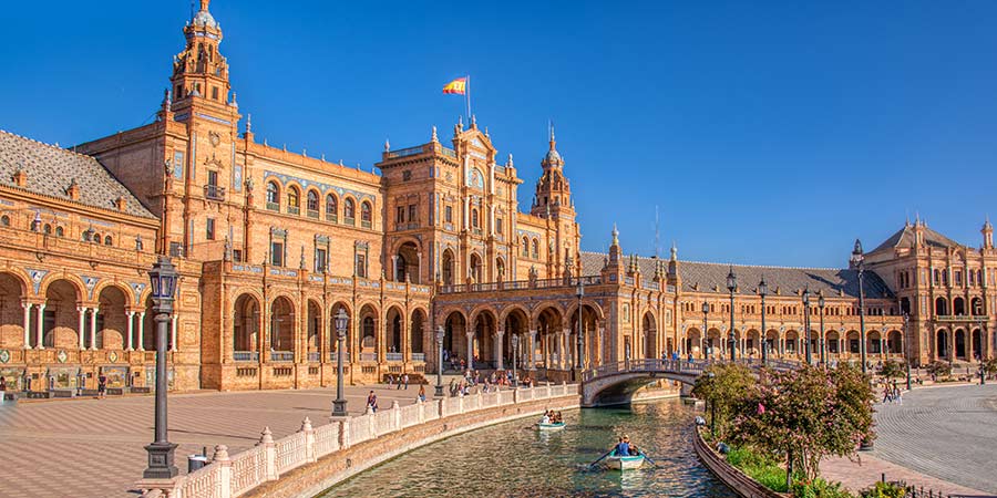 The Plaza de España in Seville captured on a warm, sunny day with clear blue skies. 